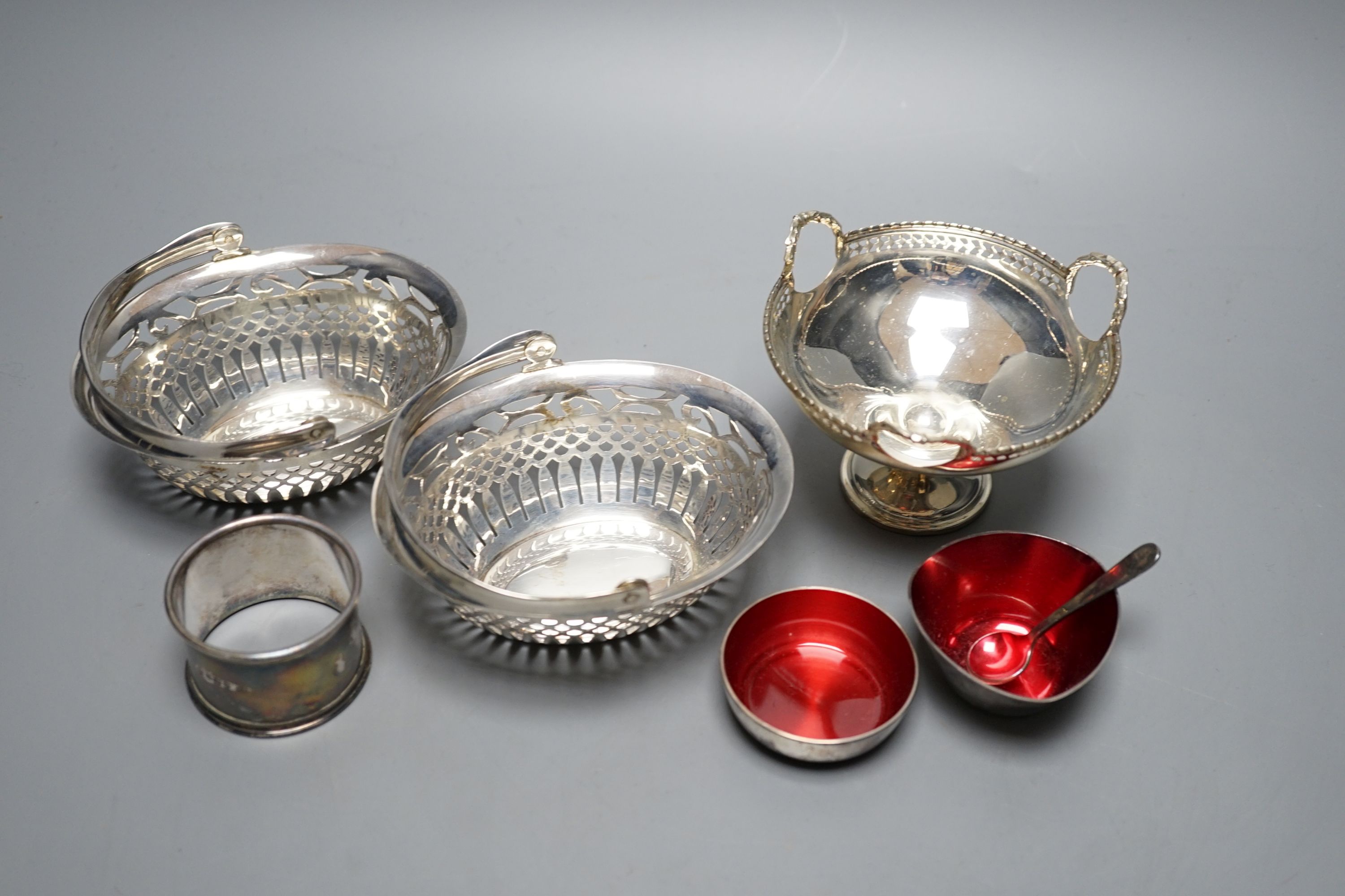 A pair of George V pierced silver bonbon baskets, a small pedestal bowl and napkin ring and two small Danish enamelled bowls.